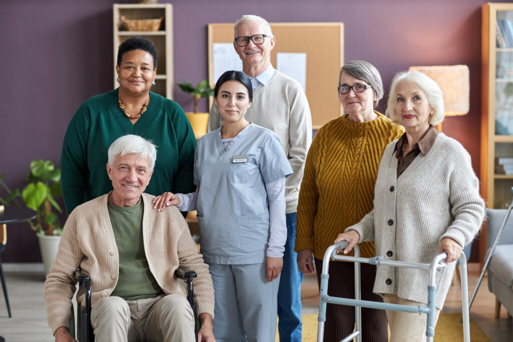 Diverse group of seniors with a caregiver at a home style assisted living community in Charlotte NC.